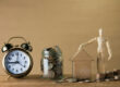 Retirement planning - photo of a clock and coins in a jar