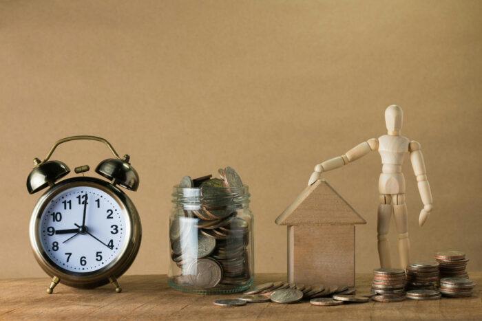 Retirement planning - photo of a clock and coins in a jar