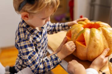 Child holding a pumpkin