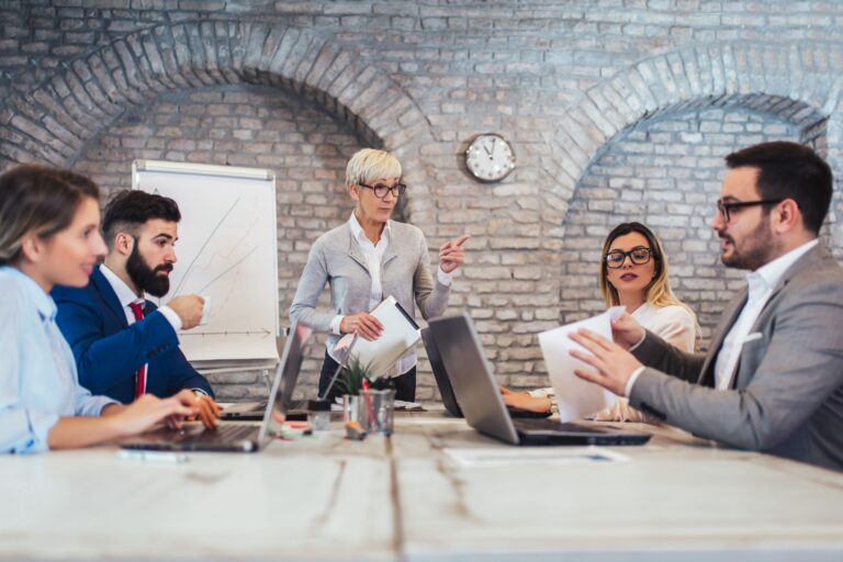 A group of colleagues sitting around a conference table. independent financial planners