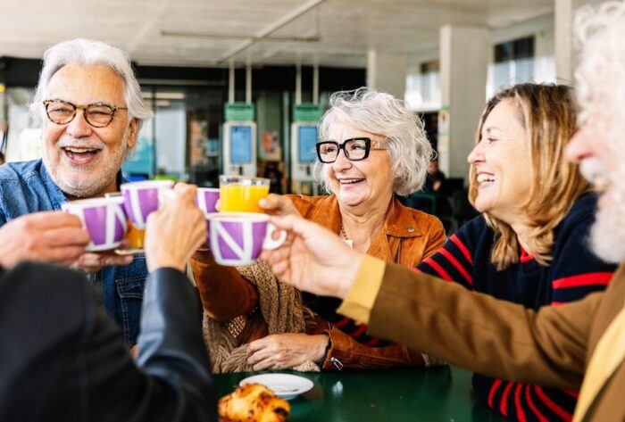 A group of people talking and drinking tea.