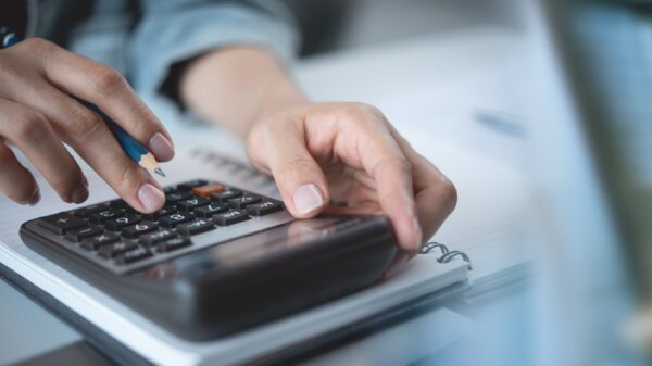 Close,Up,Woman,Hand,Using,Calculator,To,Calculate,Home,Finance A person using a calculator.