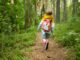 boy with back pack in forest