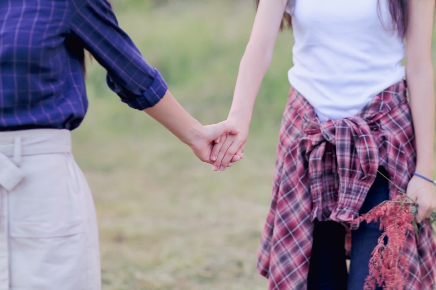 Two people holding hands