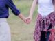 Two people holding hands