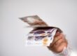 a hand holding bank notes