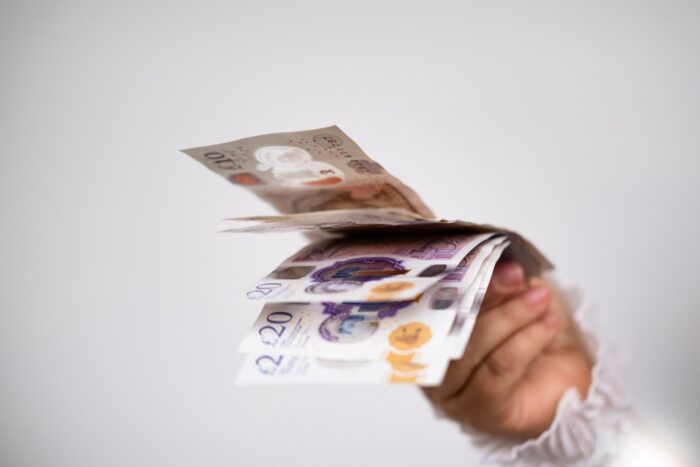 a hand holding bank notes