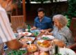 A multigenerational family eating together outdoors