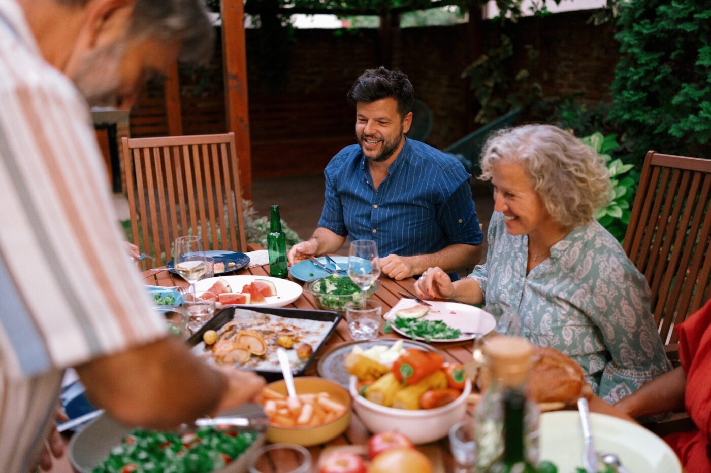 A multigenerational family eating together outdoors