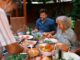 A multigenerational family eating together outdoors